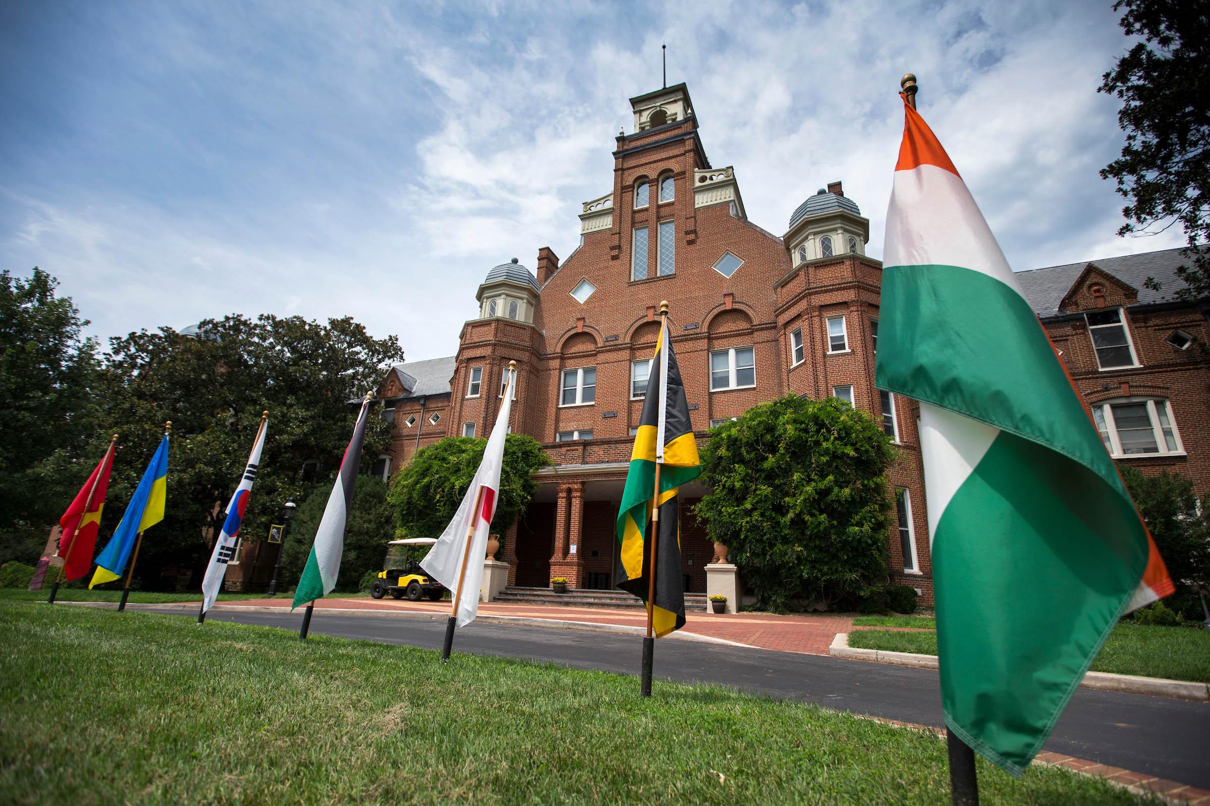 Flags of the countries of Randolph international students fly in front of Main Hall.